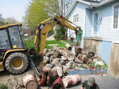 View of broken up concrete and old empty 45 gal drums